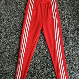 Red adidas track pants. Size small